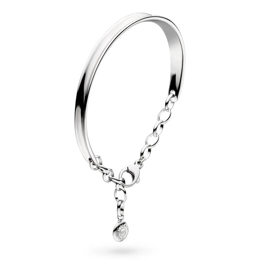 A bangle style bracelet with ribbon contours and adjustable chain in silver