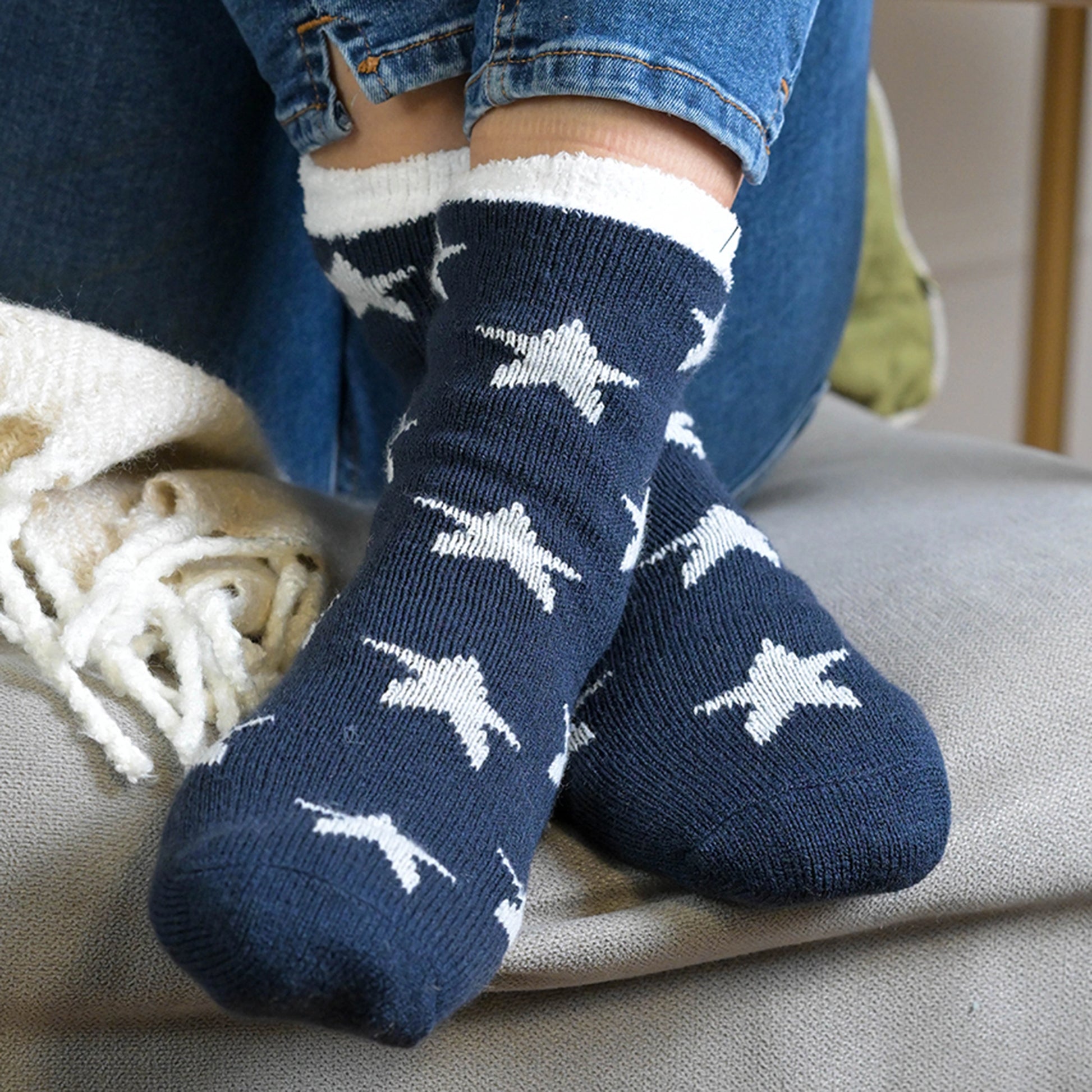 Model wearing a pair of navy socks with white star pattern