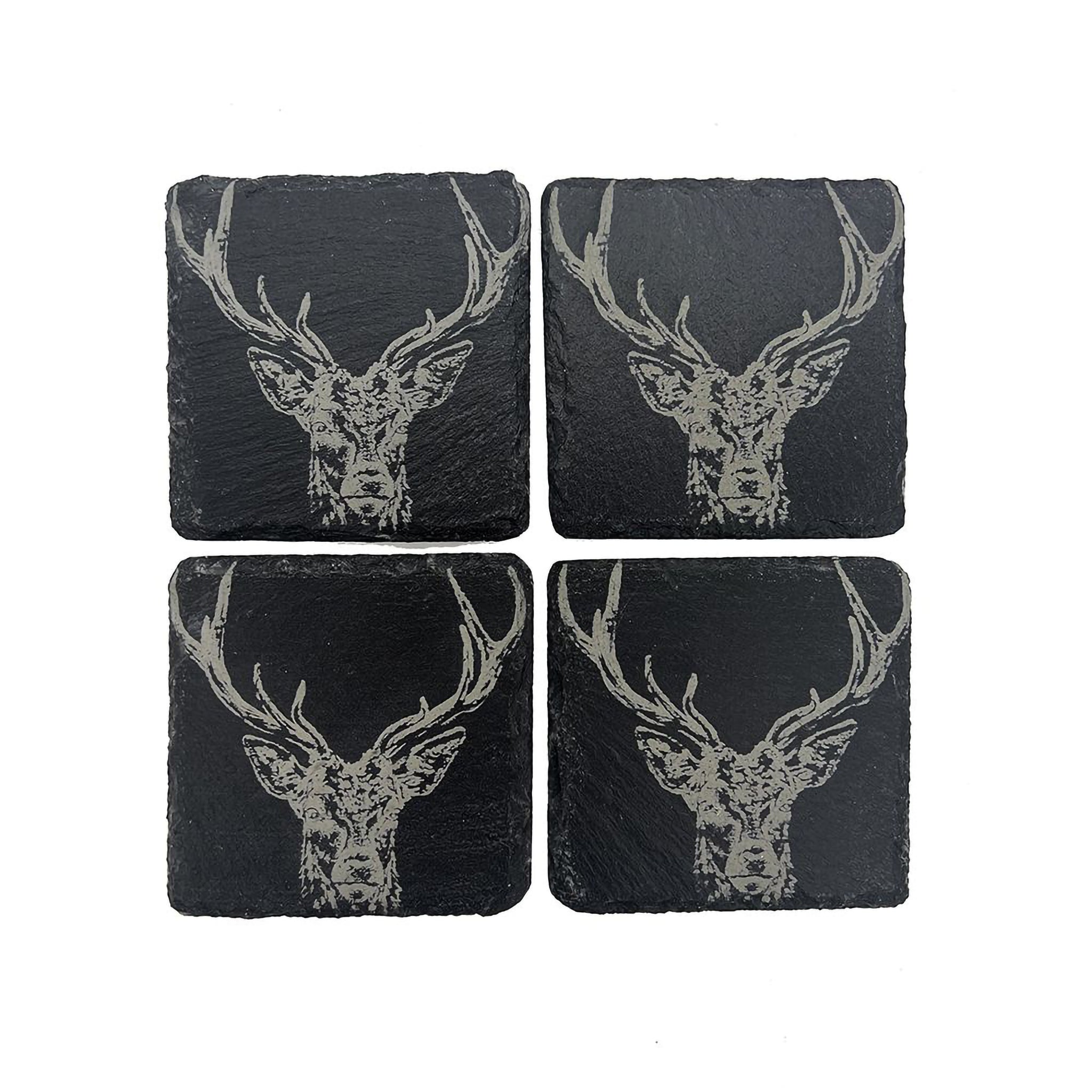 Four square slate coasters with an engraved stag head on each