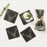 Four staged square slate coasters with an engraved stag head on each