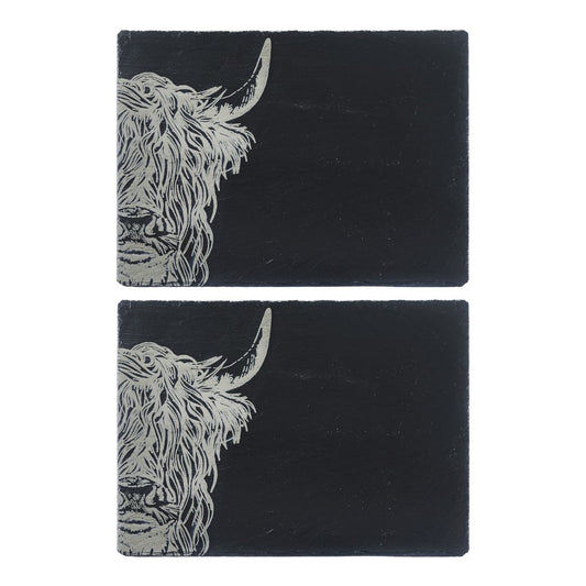 Two slate placemats with engraved Highland cow
