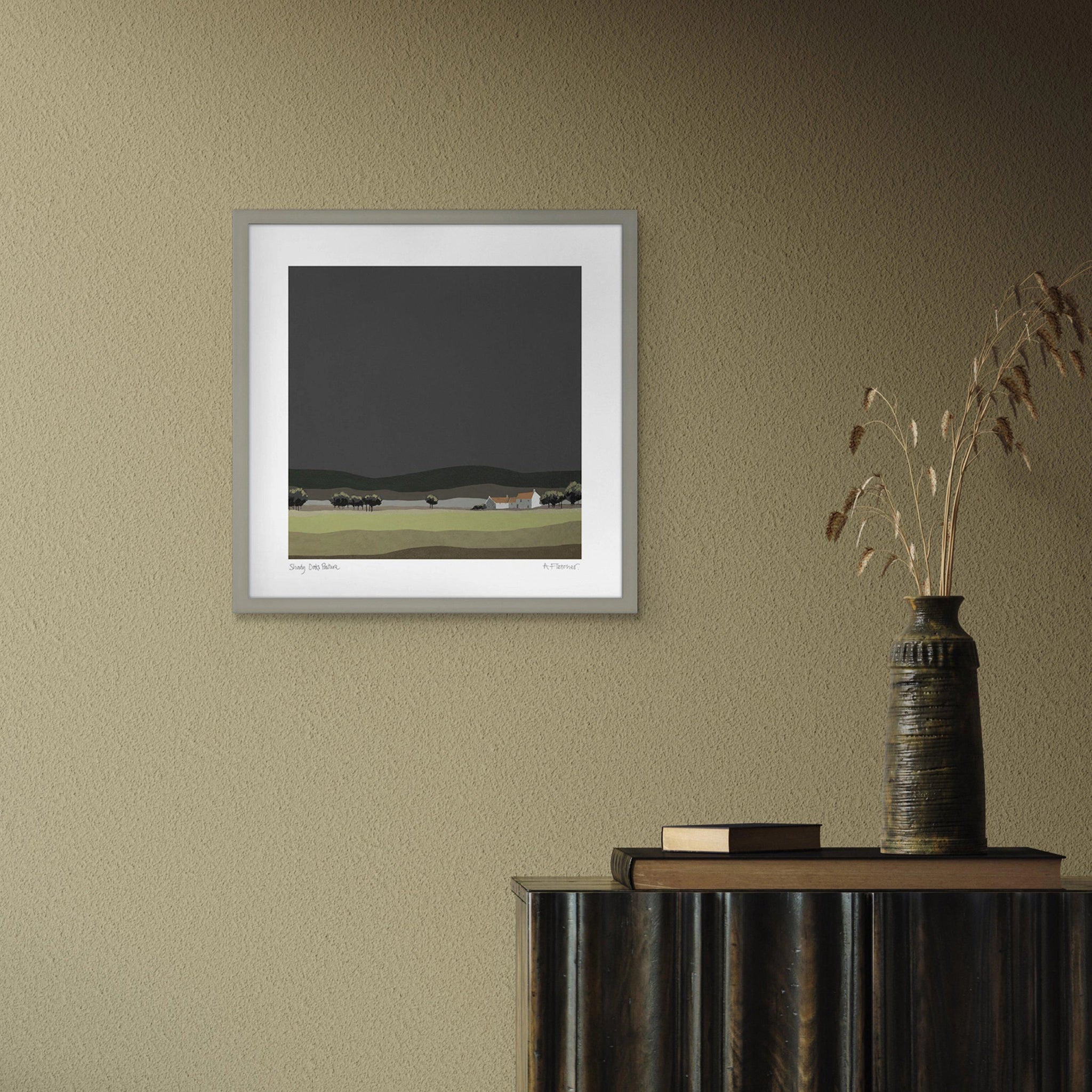 A square framed print featuring a modern landscape painting in muted colours hanging