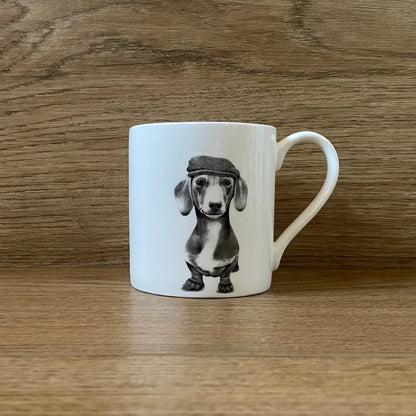 White mug with grey illustration of a sausage dog in a beret hat