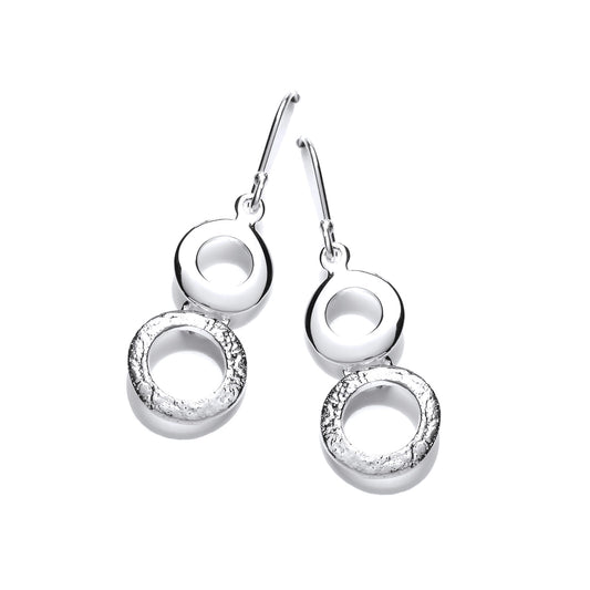 A pair of silver drop earrings with two stacked circles with hammered texture