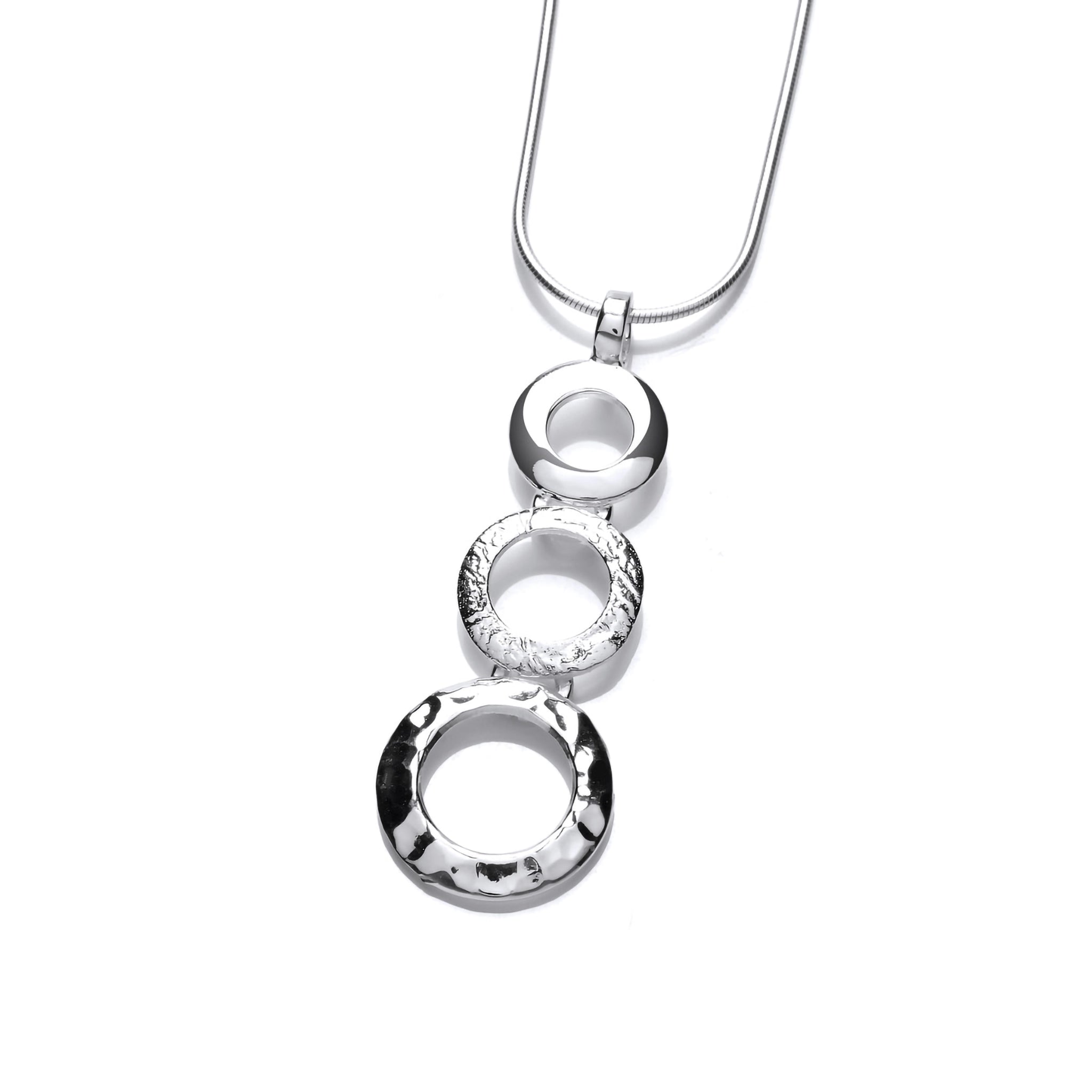 A silver pendant with three stacked circles with hammered texture