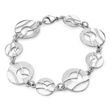 A silver bracelet featuring 8 round links with a flying sea bird in front of a cutout sun over water