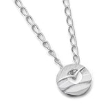 A silver small round pendant on a chain featuring a flying sea bird in front of a cutout sun over water