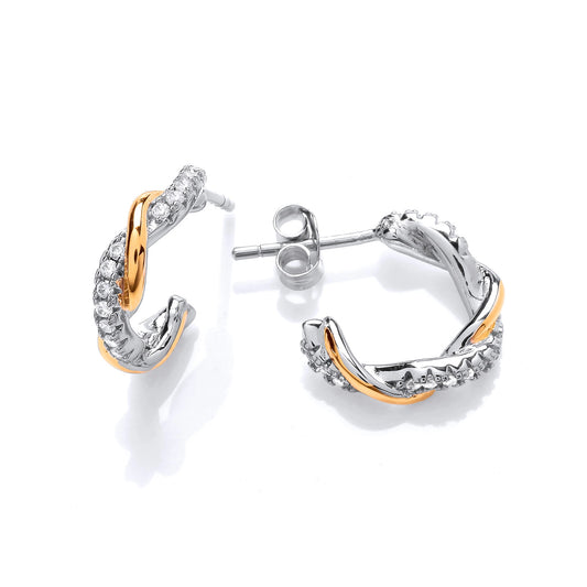 Twist hoop earrings with a gold band and a silver band set with CZ stones