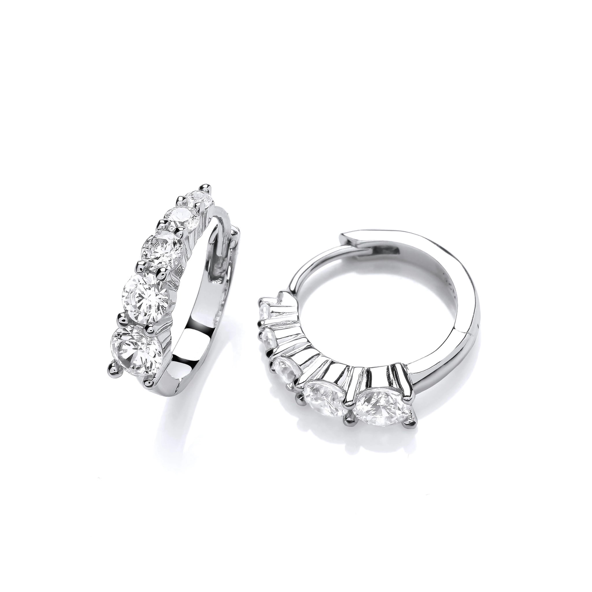 A pair of silver huggie hoop earrings featuring graduated sized CZ stones