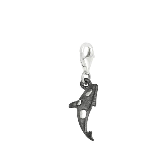 An oxidised silver charm shaped like an Orca, with a lobster claw clasp