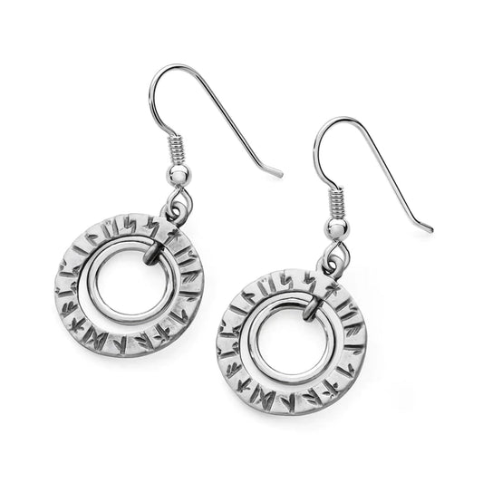 A pair of round silver earrings with a shiny inner circle and an outer circle engraved with runes