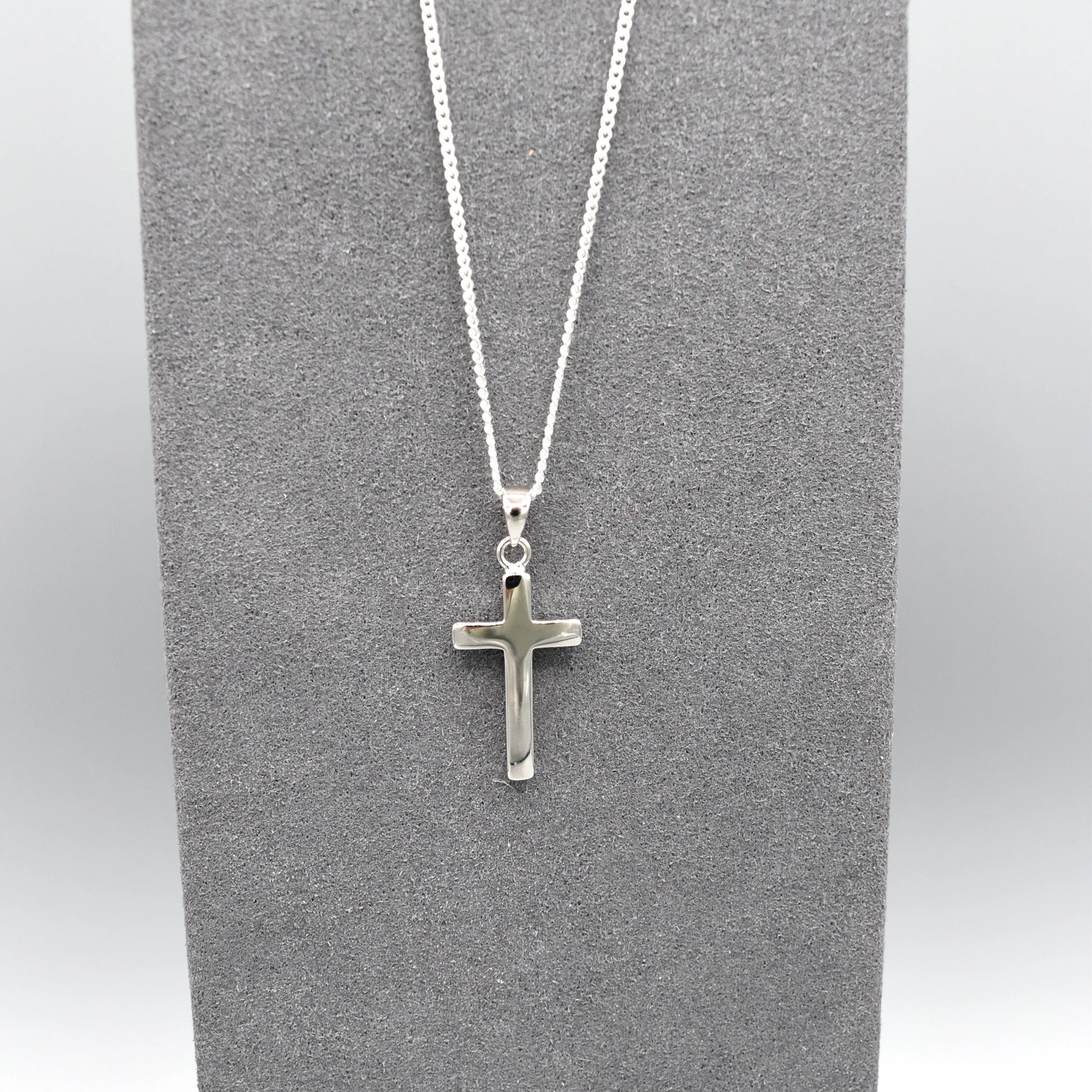 Simple silver cross pendant on silver chain