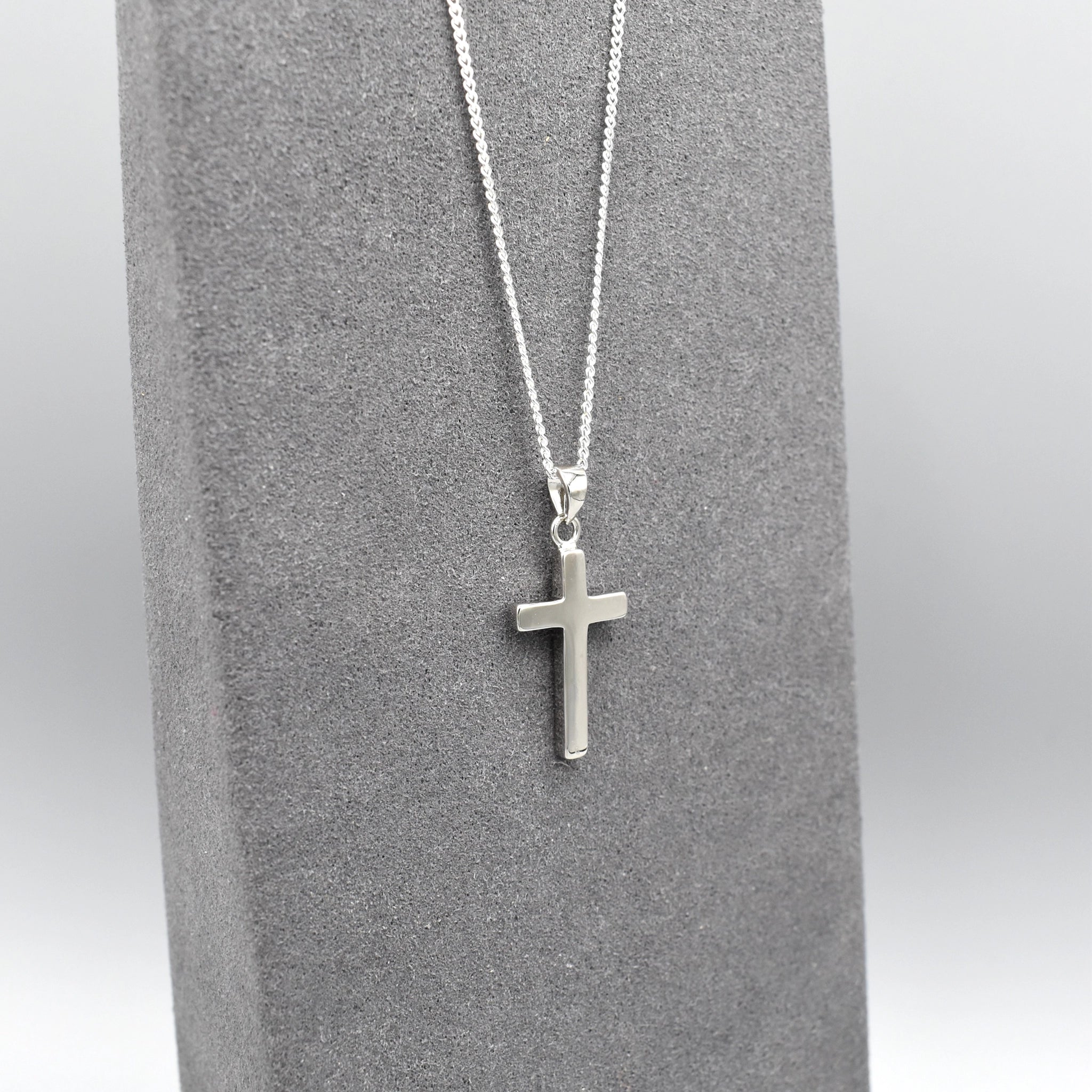 Simple silver cross pendant on silver chain