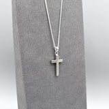 Simple silver cross pendant on silver chain