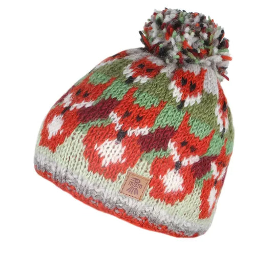 A knitted pompom hat in green and orange with rows of foxes