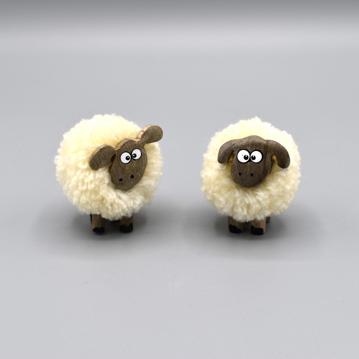 Pompom sheep with wooden legs and face