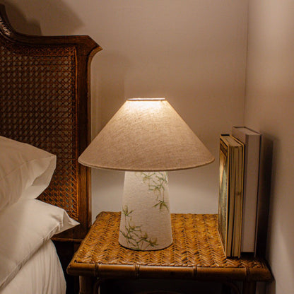 A small fabric table lamp with shade and a thistle design on the conical base lifestyle