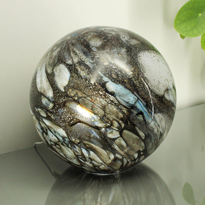 Round glass table light with a smokey quartz design lifestyle