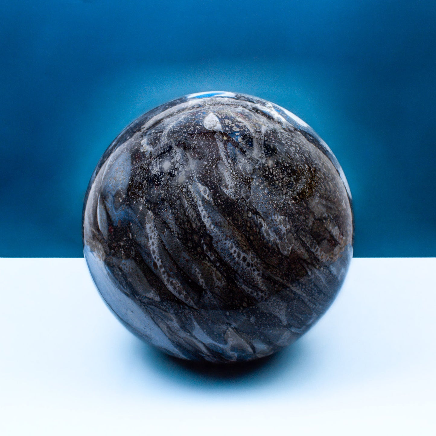 Round glass table light with a smokey quartz design off