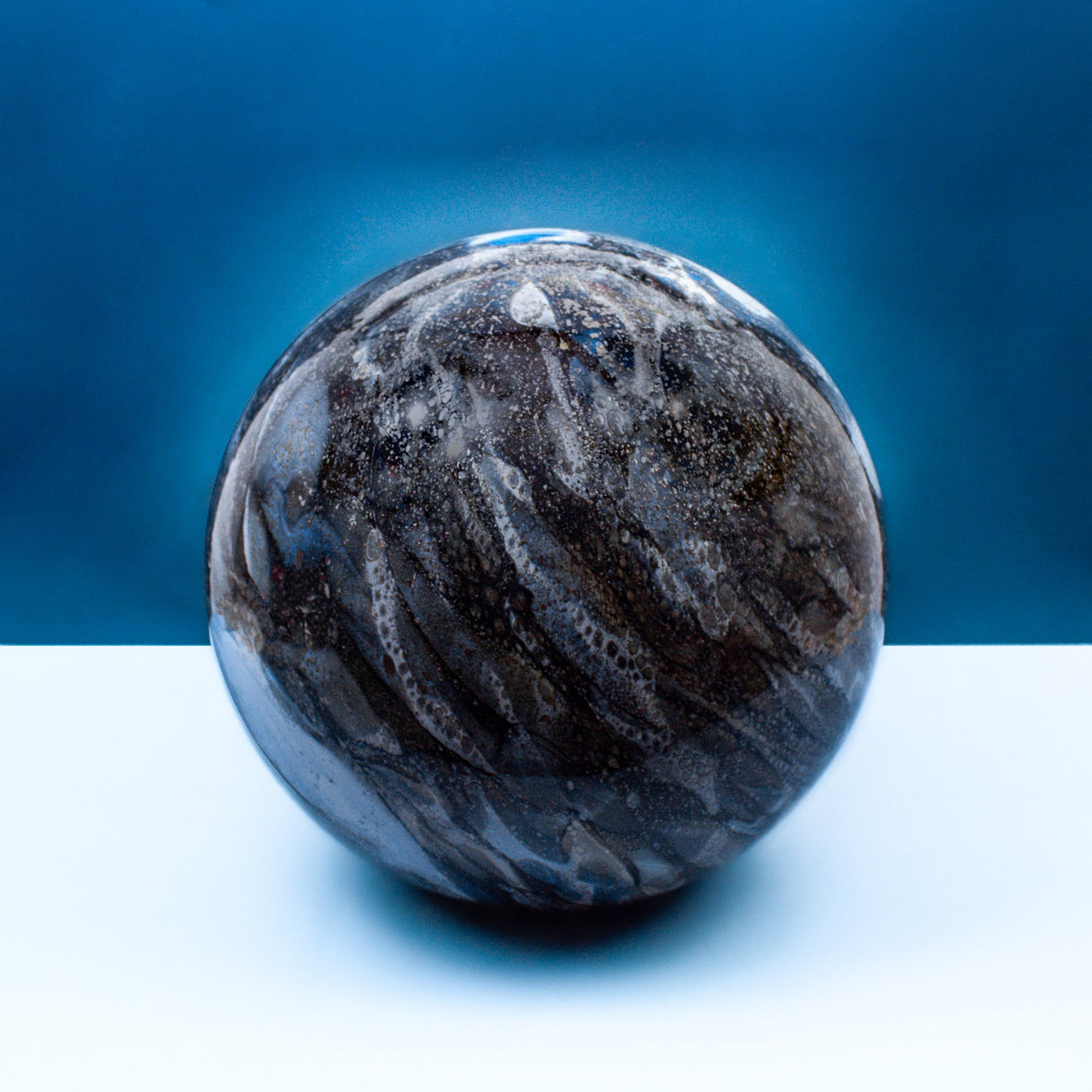 Round glass table light with a smokey quartz design off