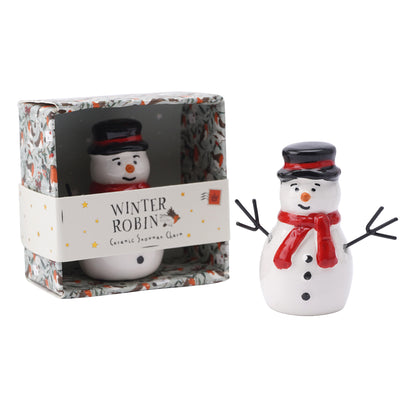 A ceramic snowman decoration with red scarf and a black top hat with packaging