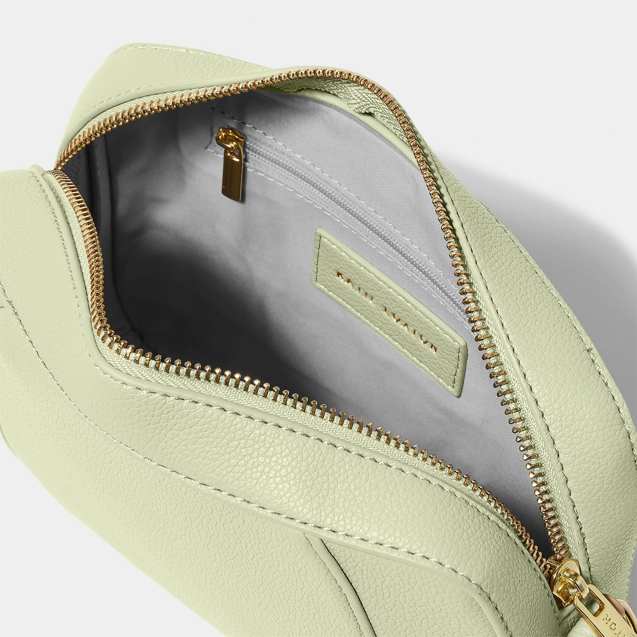 Open soft sage crossbody bag in a simple box shape with adjustable strap and gold hardware