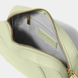 Open soft sage crossbody bag in a simple box shape with adjustable strap and gold hardware