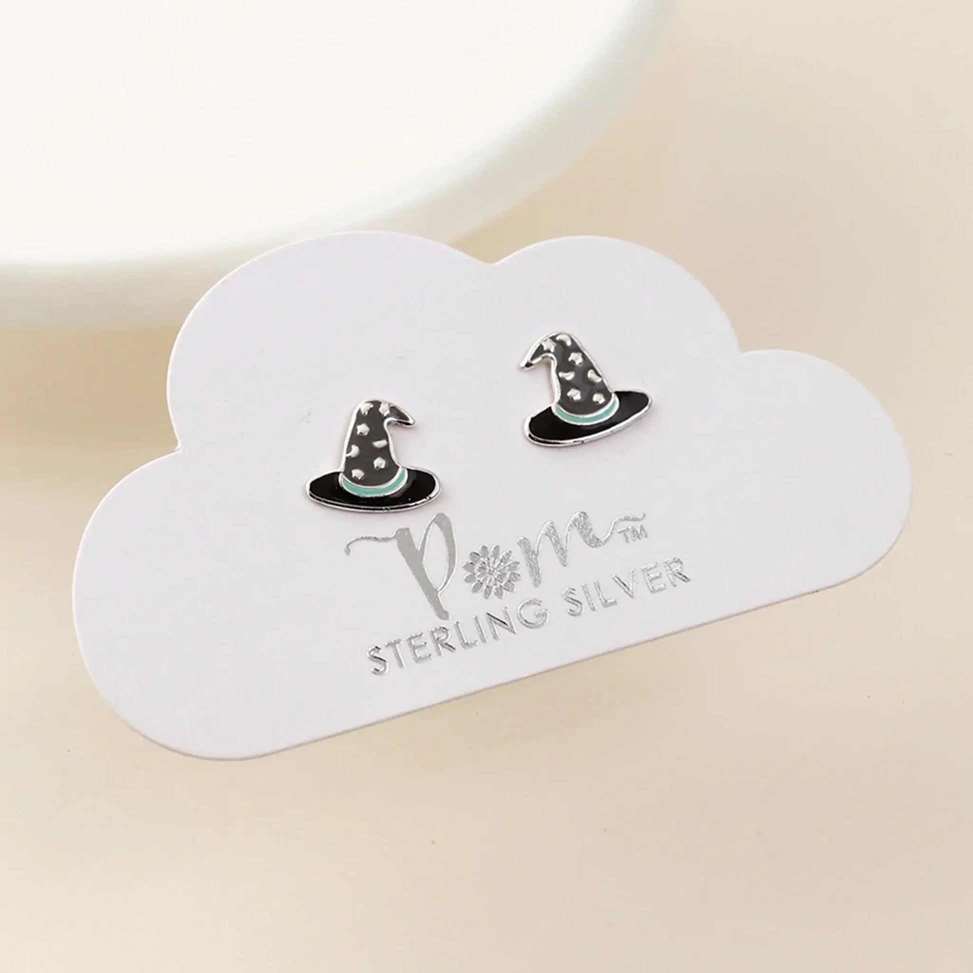 Pair of silver stud earrings shaped like witch hats with enamelled details on card