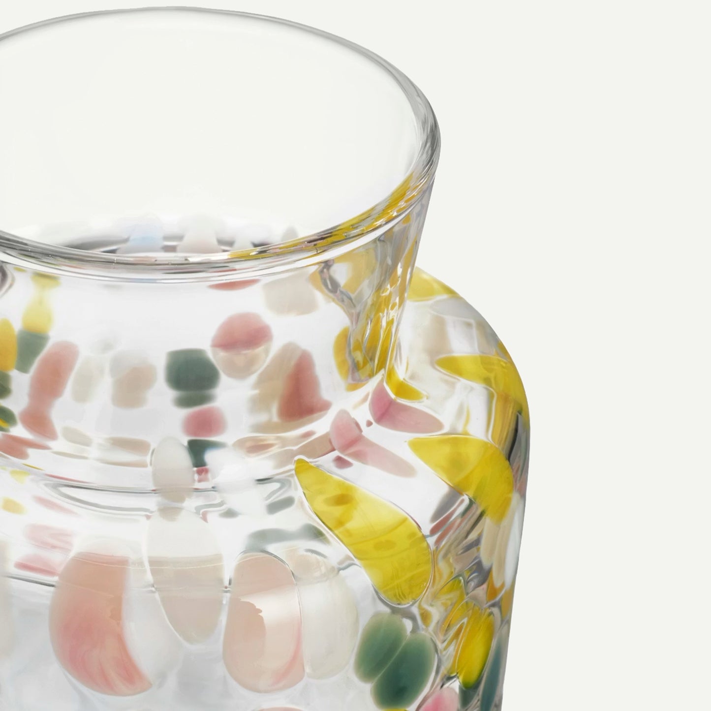 Tall glass vase with pastel and white pebble details top detail