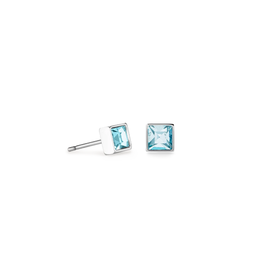 A pair of square silver stud earrings featuring an aqua crystal stone