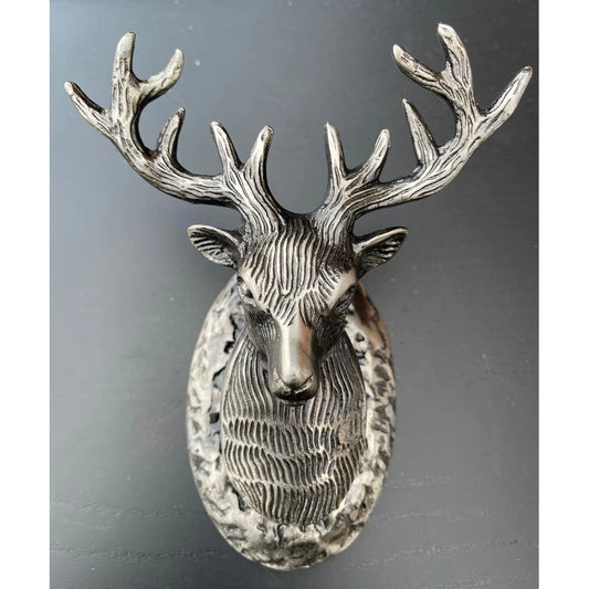 A silver gunmetal coloured stag shaped door knocker