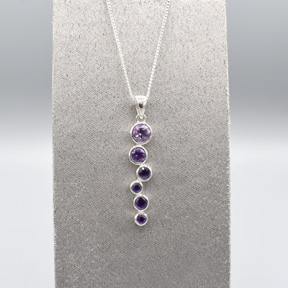 Silver pendant with cascading round amethyst stones and a silver chain