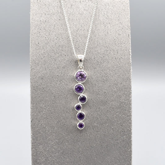Silver pendant with cascading round amethyst stones and a silver chain