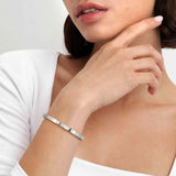 Model wearing a stainless steel bangle with pave CZ hearts