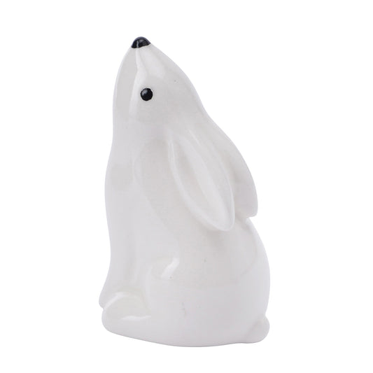 A ceramic white hare decoration looking up at the sky