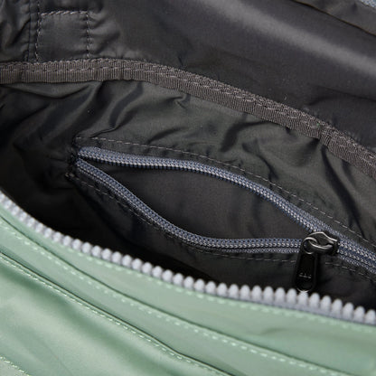 A square mint green nylon bag with grey internal zip pocket