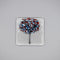 A clear glass square coaster with a blue & red tree design