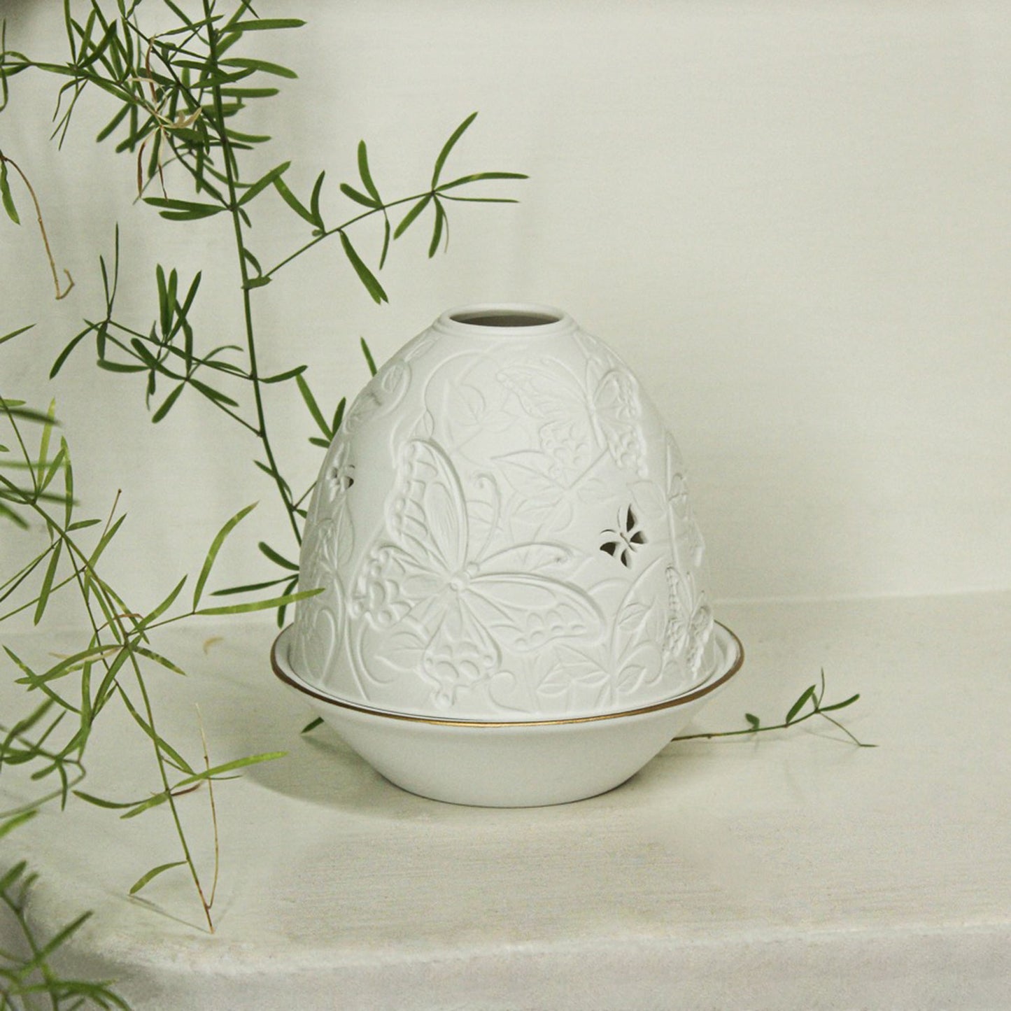 White porcelain tall dome candle holder with engraved butterflies and gold rimmed plate