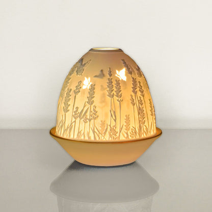 White porcelain tall dome candle holder with engraved lavender and gold rimmed plate lit up