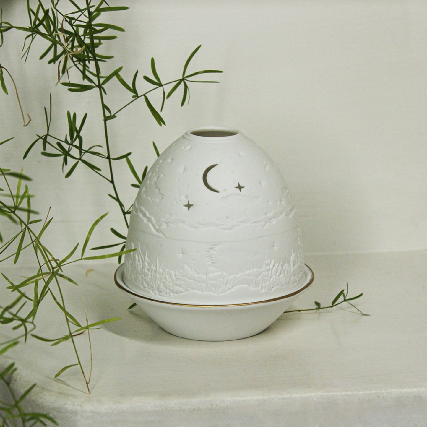 White porcelain tall dome candle holder with engraved starry night scene and gold rimmed plate