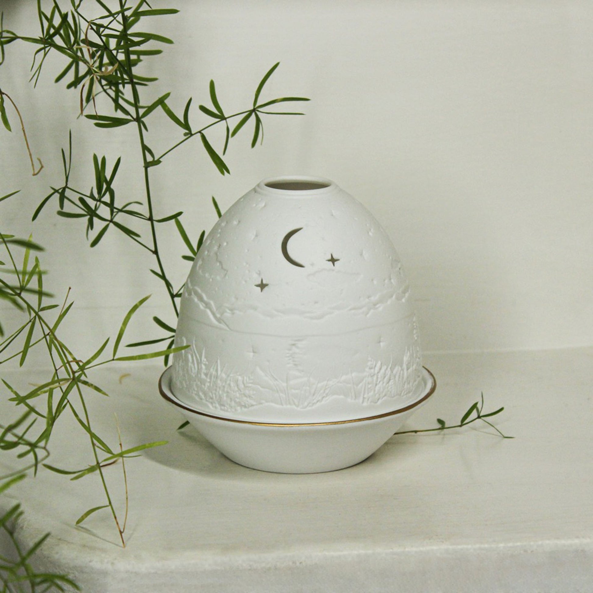 White porcelain tall dome candle holder with engraved starry night scene and gold rimmed plate