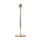 A tall simple gold metal dinner candle stick