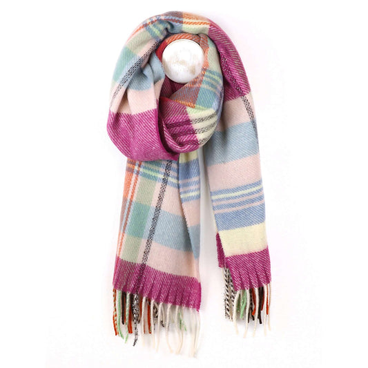 A tartan check scarf in pastel colours and brown with tassel fringe