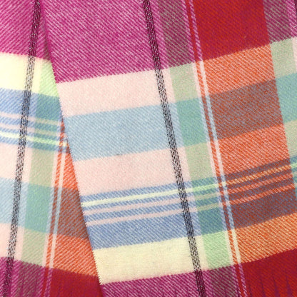 A tartan check scarf in pastel colours and brown with tassel fringe pattern detail