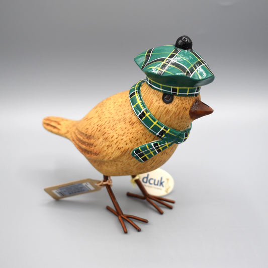 A little wooden garden bird wearing a dark green tartan Scottish beret and matching scarf