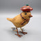 A little wooden garden bird wearing a red tartan Scottish beret and matching scarf