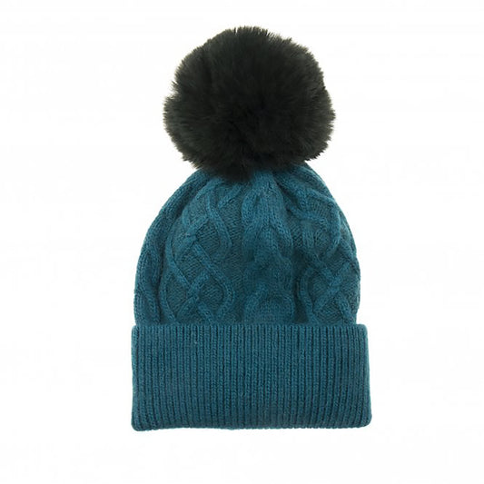 A simple deep blue teal cable knit hat with large fluffy pompom