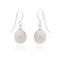 A pair of drop earrings with teardrop shaped pink pearls and silver hooks 