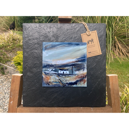 A slate mounted ceramic tile art with a white cottage and telephone pole