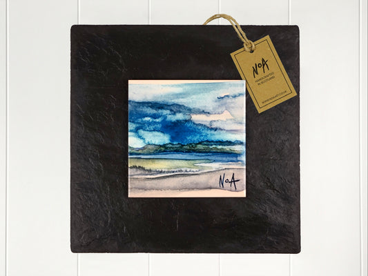 Wall art of a watercolour landscape done in an abstract style onto a square ceramic tile mounted on square slate